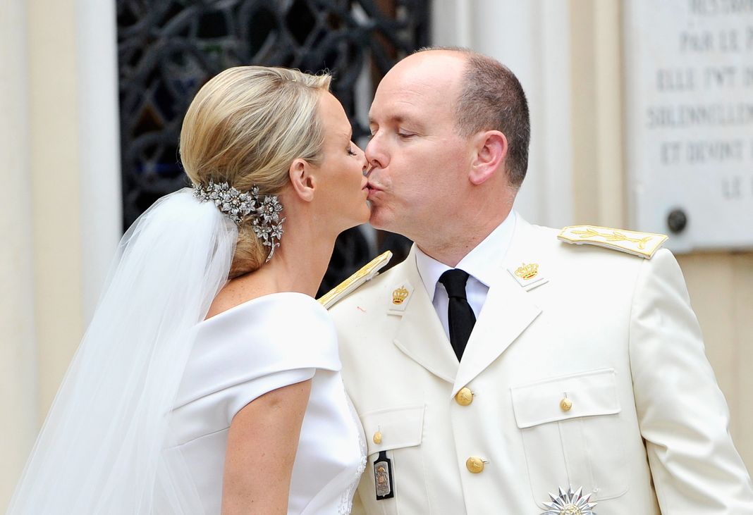 Принцесса Монако Шарлен и принц Монако Альбер II целуются на выходе из церкви Сент-Девот после свадебной церемонии